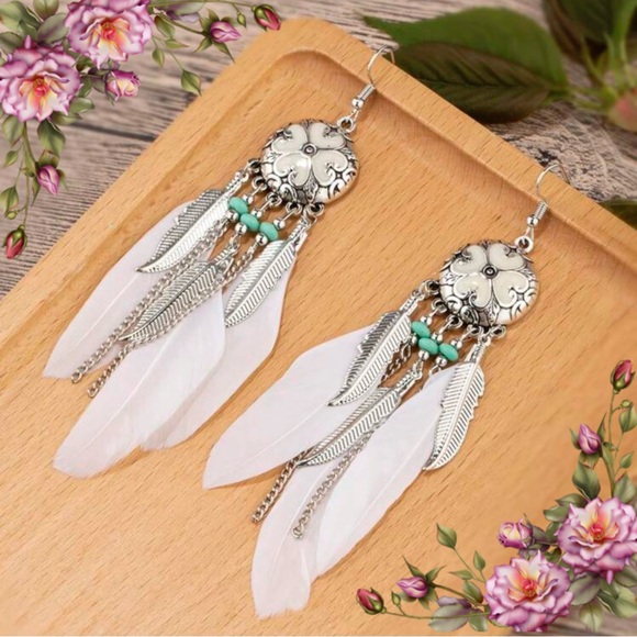Bohemian Silver and White Feather drop
Earrings - Picture 1 of 10